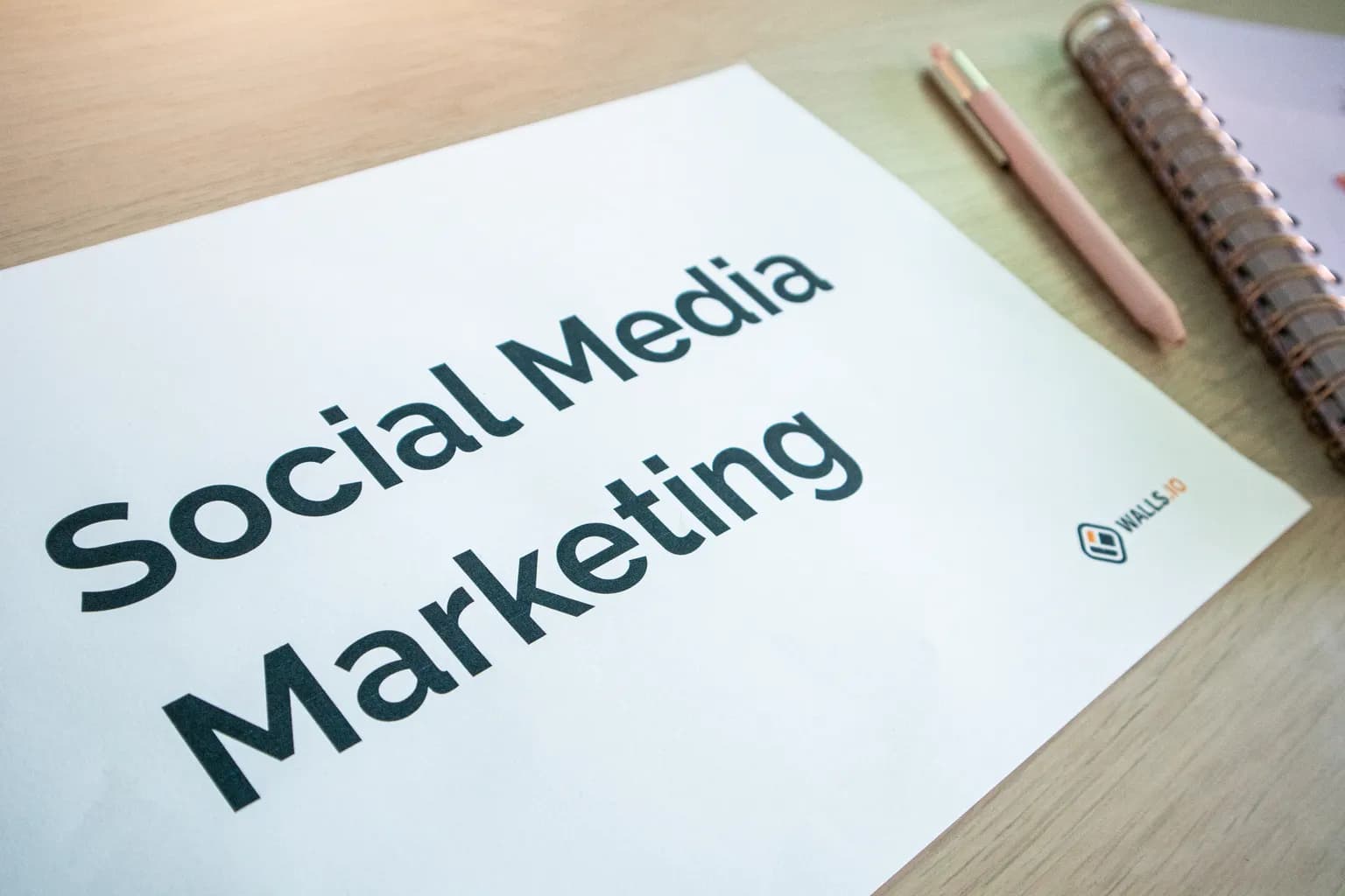 A social media marketing plan laid out beside a notebook