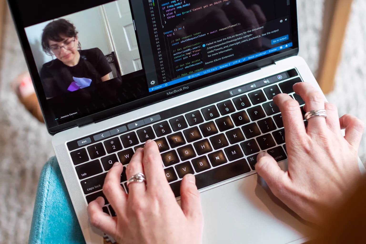 A developer joining a video call while working with code